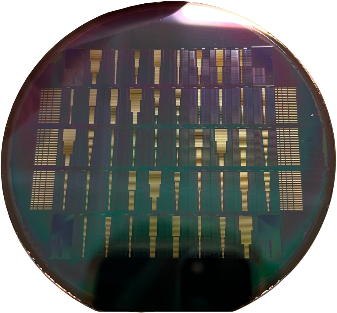 A silicon wafer patterned with repeated photonic chips.